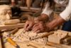 Artisans working in a wooden furniture workshop creating handcrafted pieces with skill and precision
